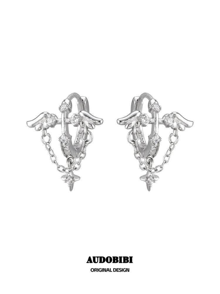 Wing hoop earrings with draped chains and hanging star details.