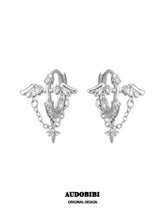 Wing hoop earrings with draped chains and hanging star details.