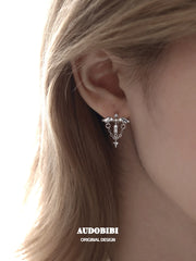 Winged Grace Judgment Angel Wing & Chain Hoop Earrings, shown worn by a model.