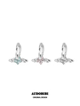 Mini wing hoop earrings shown in blue, pink and white.