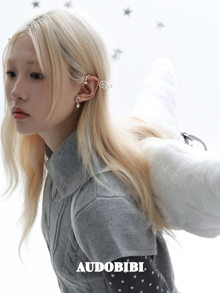 Large openwork wing ear cuff, worn with other jewelry in a model portrait.