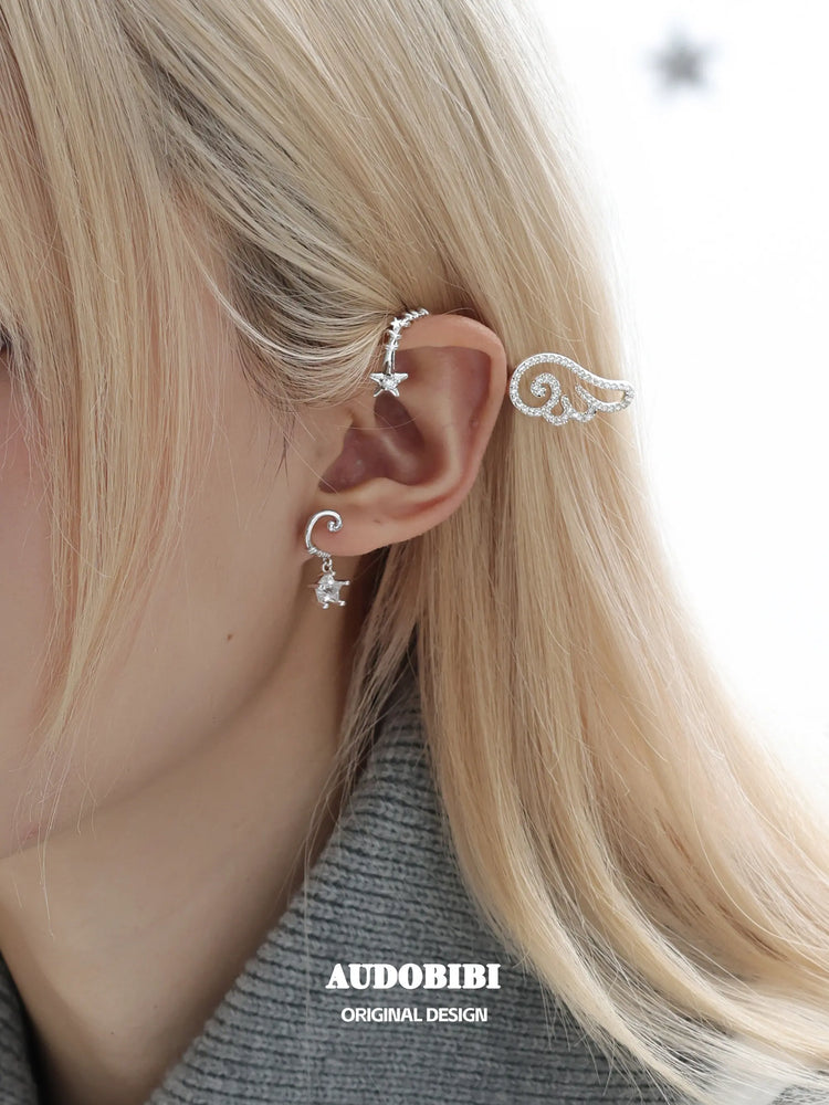 Winged Grace Judgment Angel Sparkling Wing Ear Cuff, shown worn by a model.