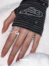 Openwork wing ring, shown on the hand or wrist with other jewelry.