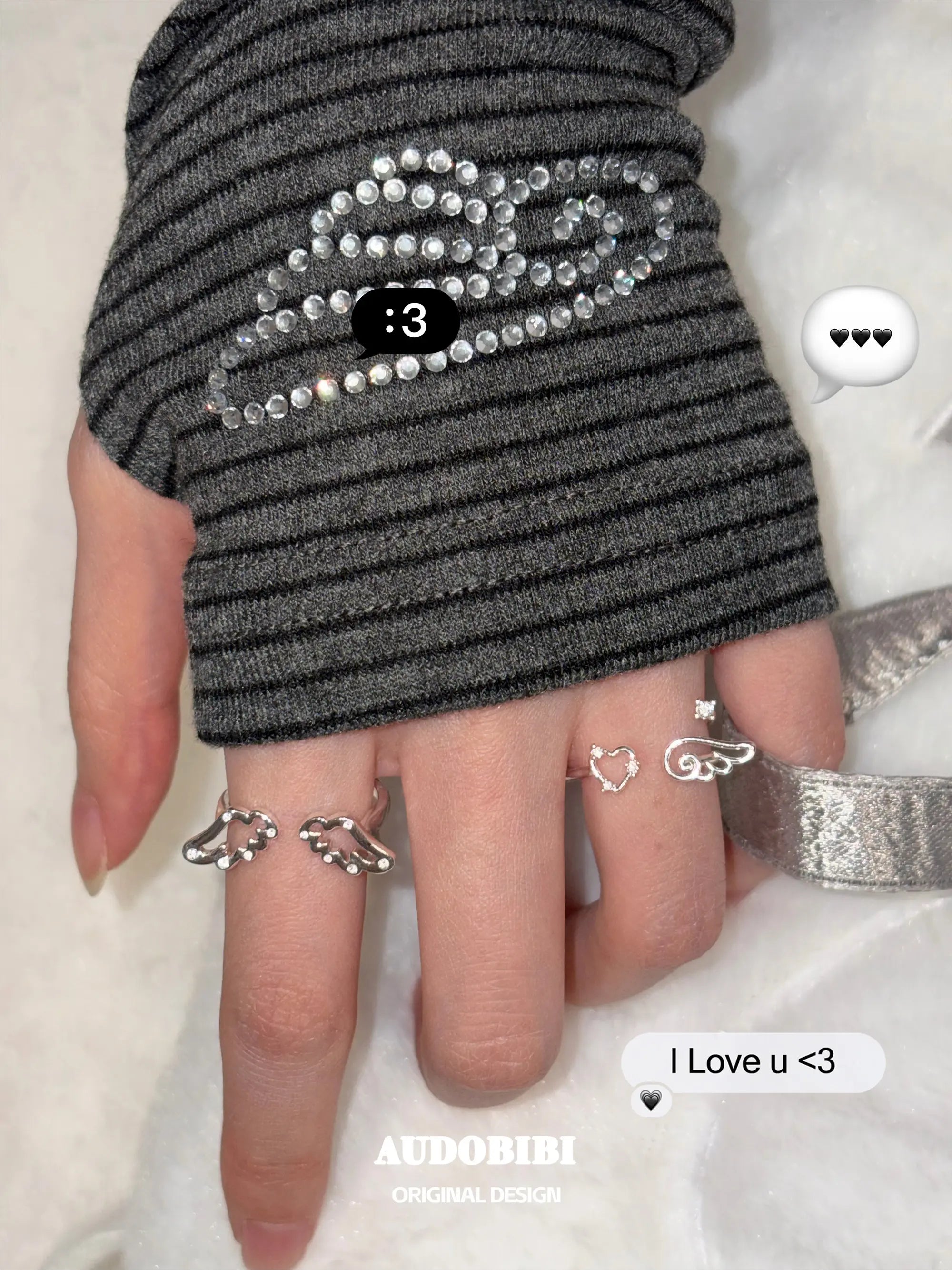 Openwork wing ring, shown on the hand or wrist with other jewelry.