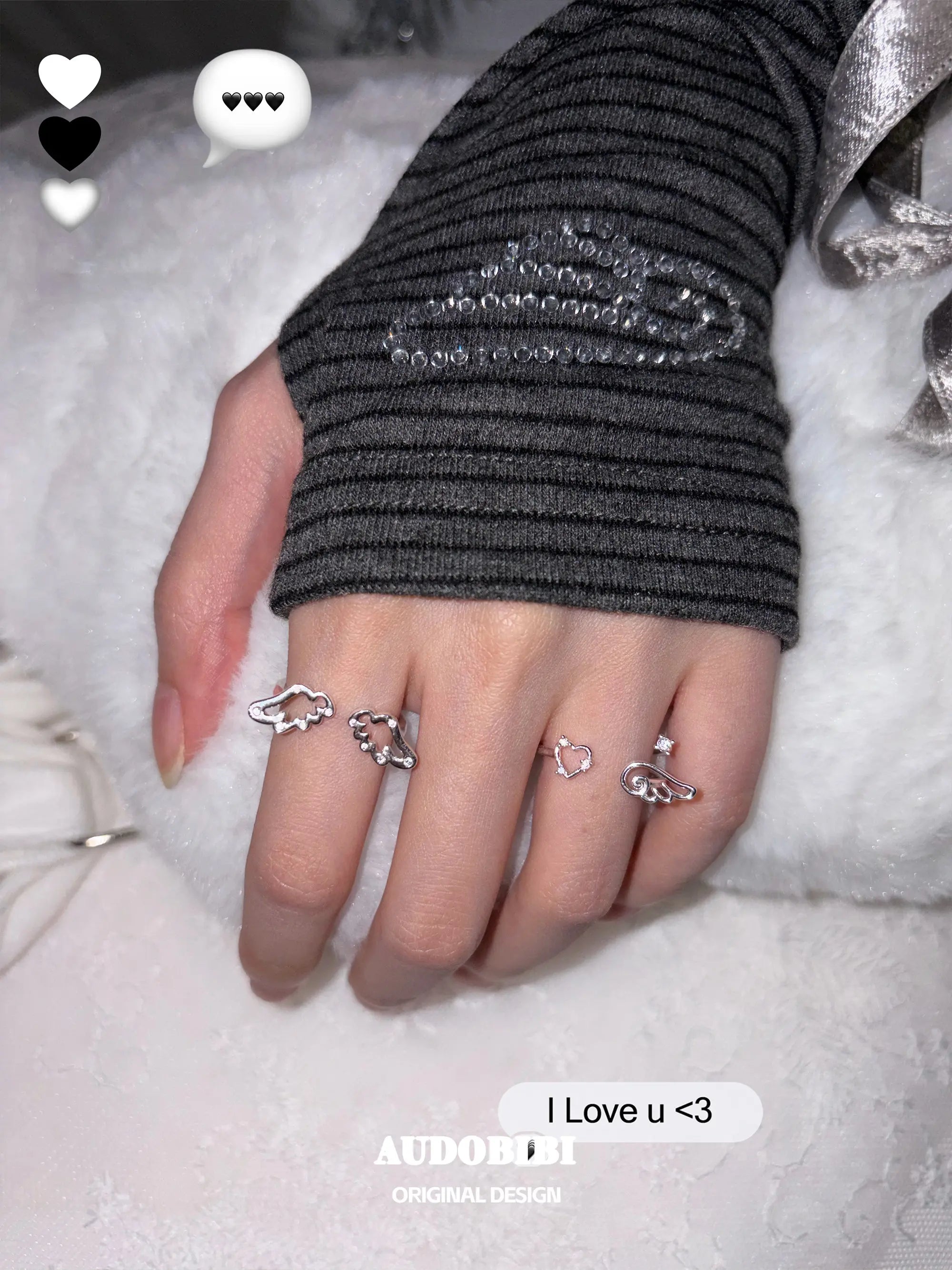 Openwork wing ring, shown on the hand or wrist with other jewelry.