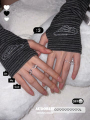 Openwork wing ring, shown on the hand or wrist with other jewelry.