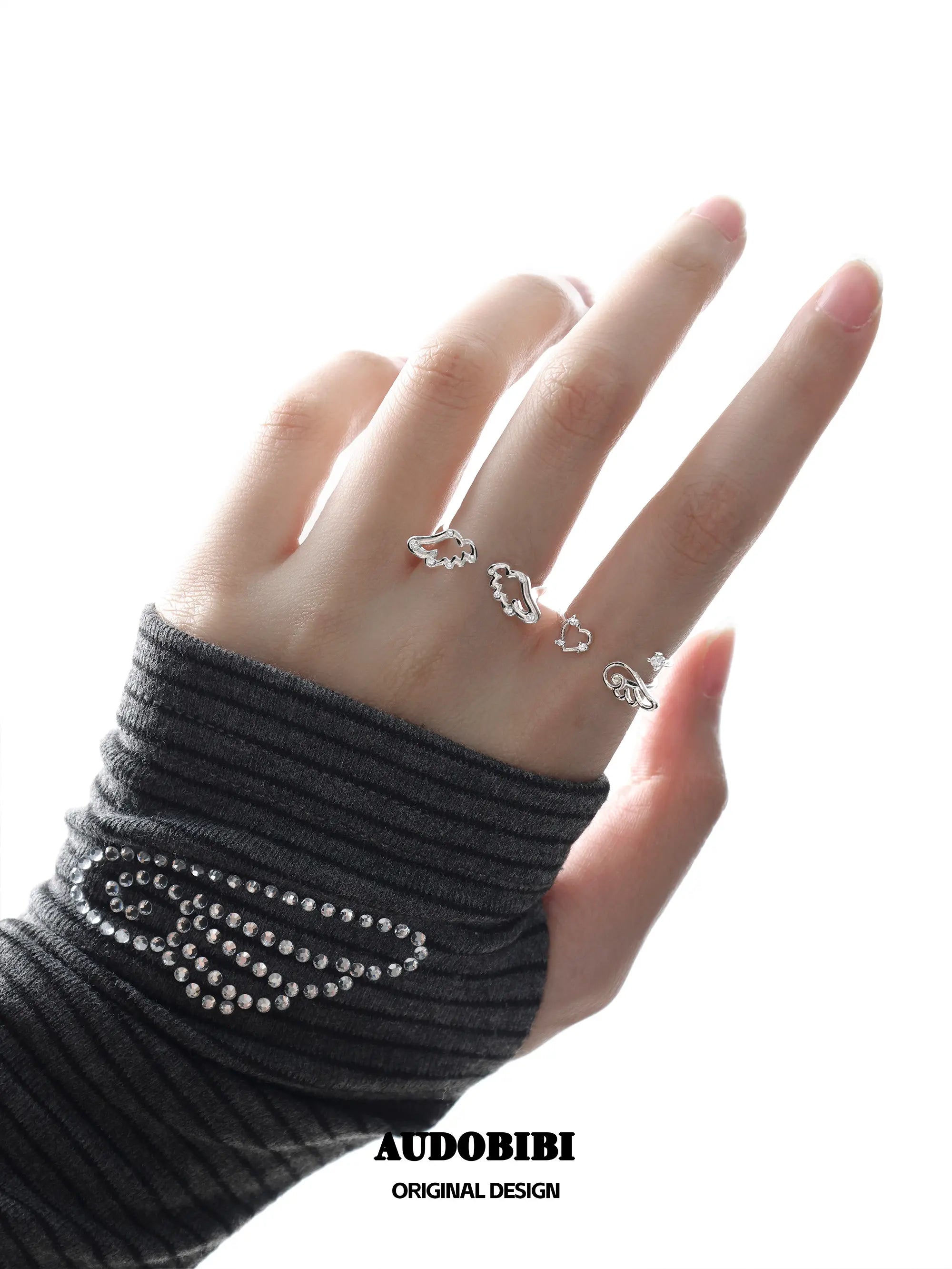 Winged Grace Wing Slumber Zircon Angel Wing Open Ring, shown worn by a model.
