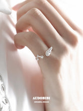 Winged Grace Dreamcore Angel Wing & Star Pinky Ring, shown worn by a model.