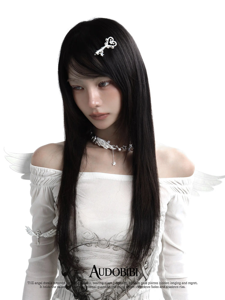 Ornate key hair clip, worn with other jewelry in a model portrait.
