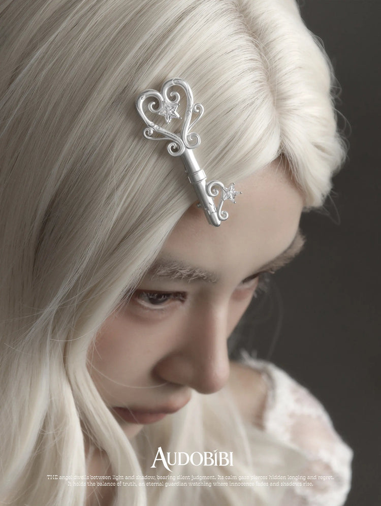 Winged Grace Key Hair Clip, shown worn by a model.