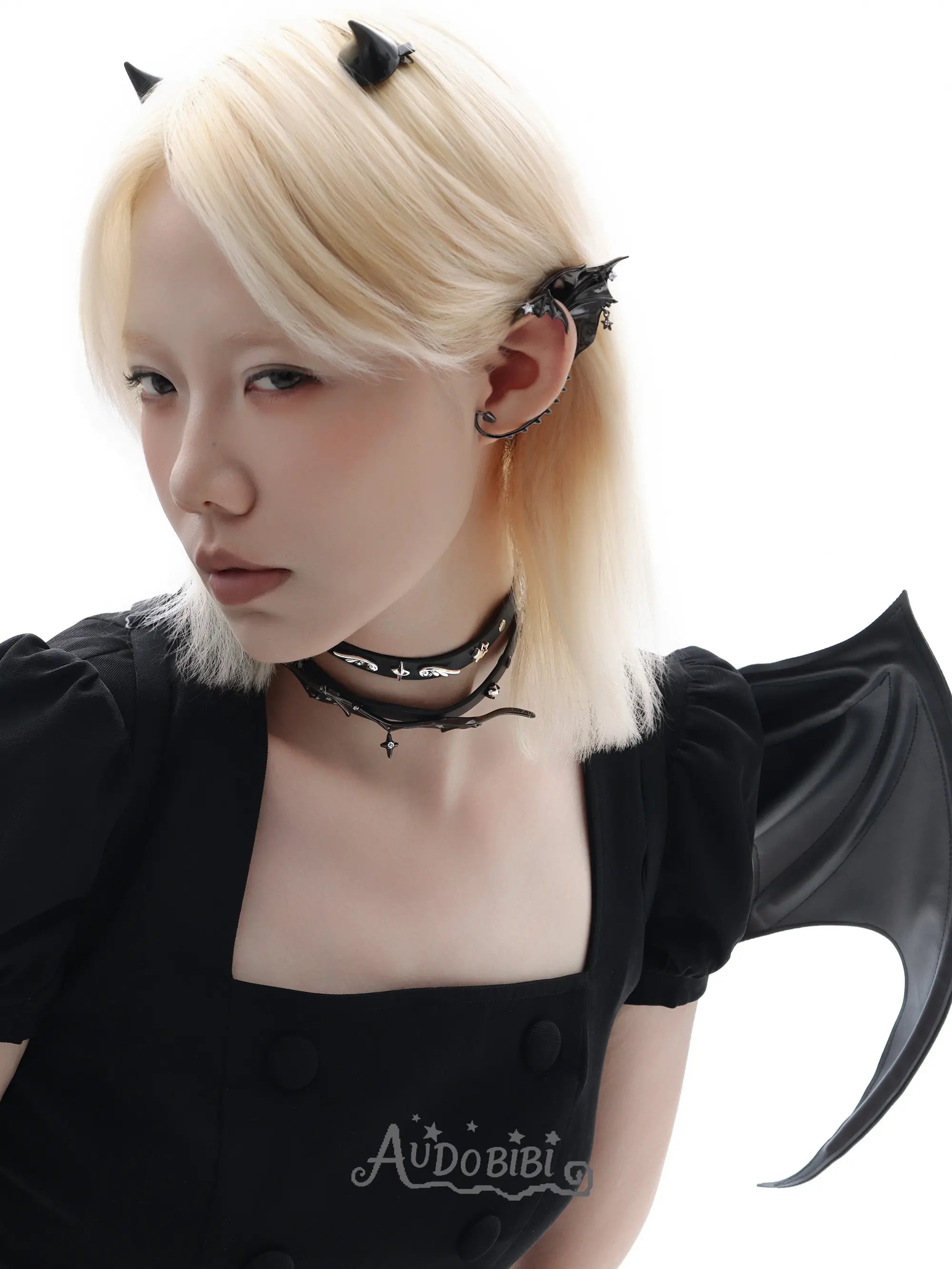 Angel and Devil leather straps with winged hardware, shown worn as bracelets.