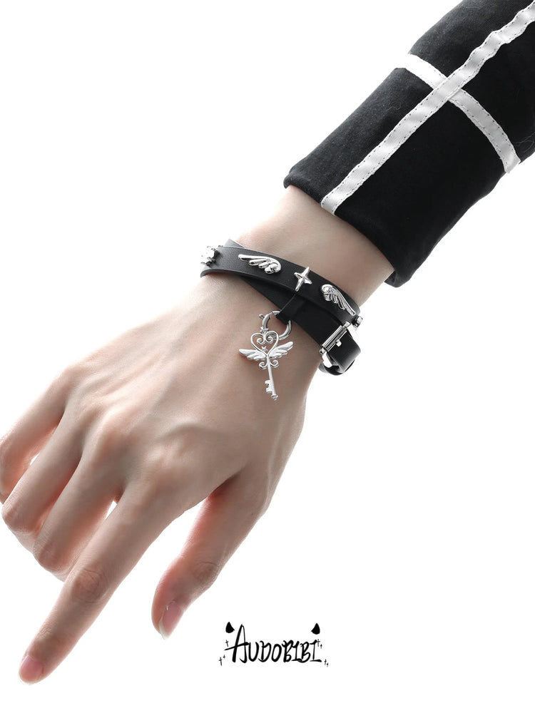 Angel and Devil leather straps with winged hardware, shown worn as bracelets.
