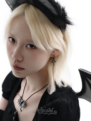 Black bat-wing pendant necklace, worn with other jewelry in a model portrait.