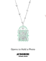 Window-shaped photo locket necklace, shown on the hand or wrist with other jewelry.