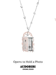 Window-shaped photo locket necklace, shown on the hand or wrist with other jewelry.