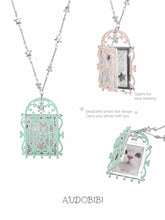 Window-shaped photo locket necklace, shown on the hand or wrist with other jewelry.