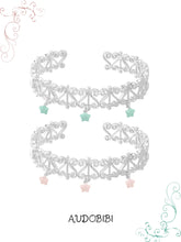 Two openwork bangles with mint and pink star drops.