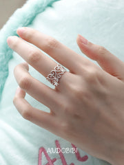 Openwork window ring with a hanging star, shown on the hand or wrist with other jewelry.