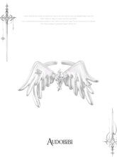Open ring with raised feathered wings on a white background.