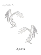 Two long wing ear cuffs on a white background.