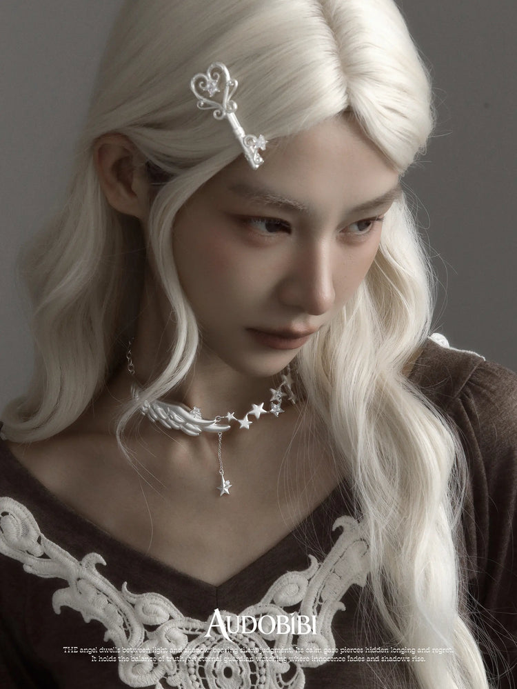 Winged Grace Starlit Angel Wing Pendant Necklace, shown worn by a model.