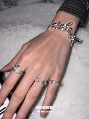 Musical-note open-ring designs, shown on the hand or wrist with other jewelry.