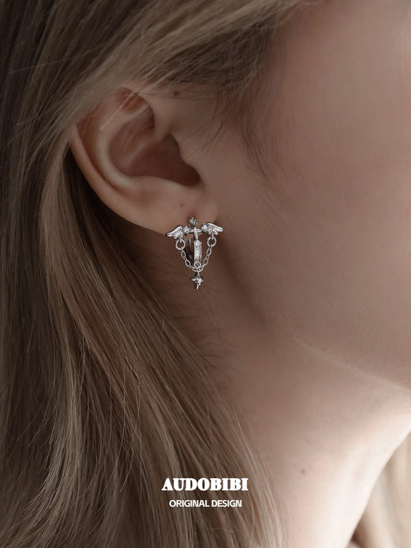 Winged Grace Judgment Angel Wing & Chain Hoop Earrings, shown worn by a model.