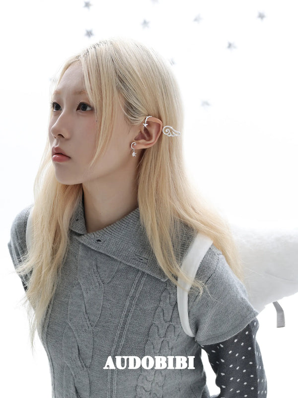 Large openwork wing ear cuff, worn with other jewelry in a model portrait.