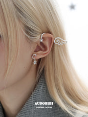 Winged Grace Judgment Angel Sparkling Wing Ear Cuff, shown worn by a model.
