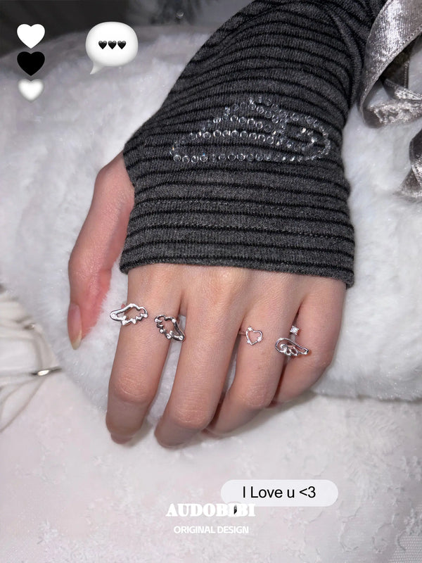 Openwork wing ring, shown on the hand or wrist with other jewelry.