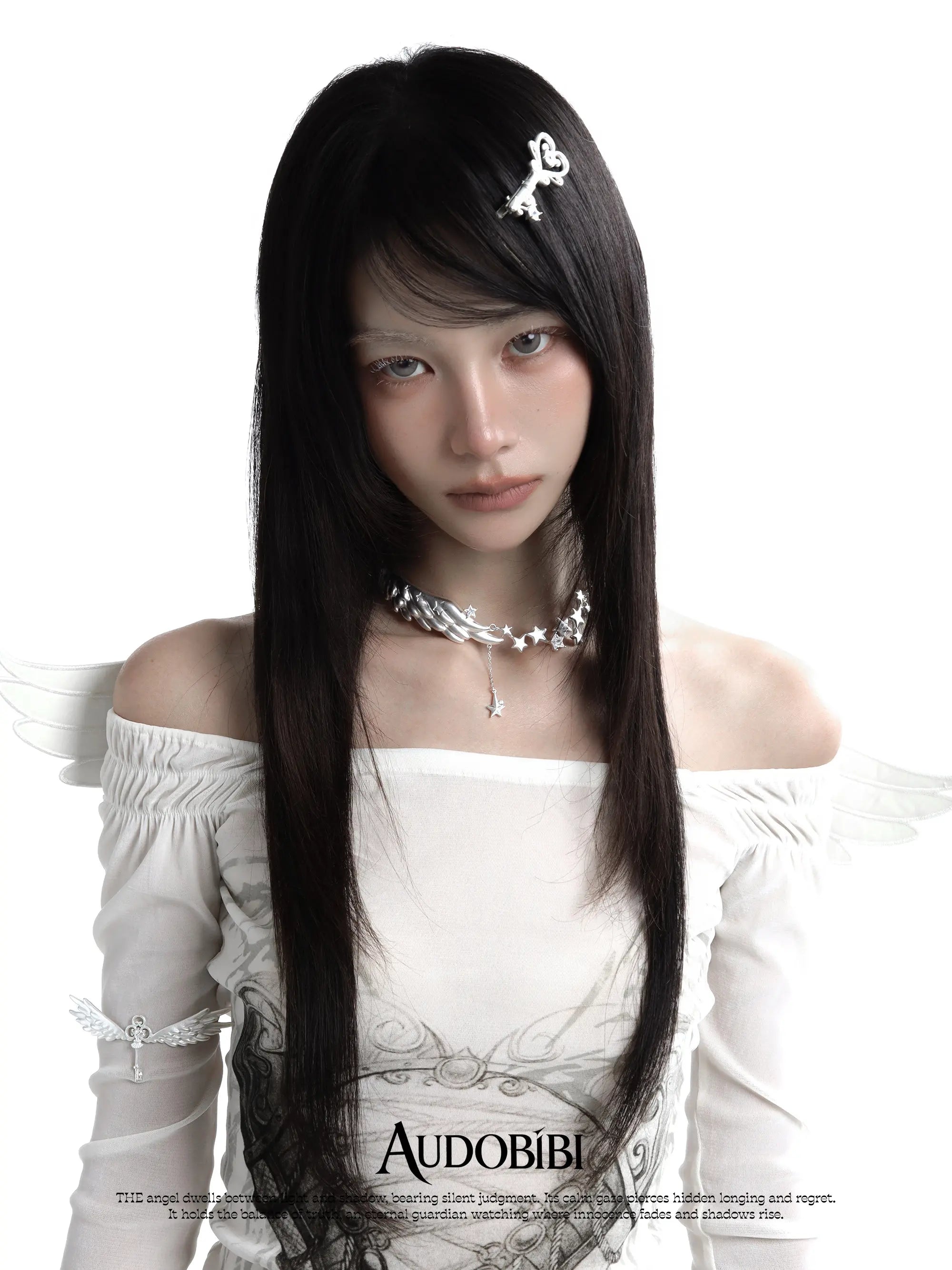Ornate key hair clip, worn with other jewelry in a model portrait.