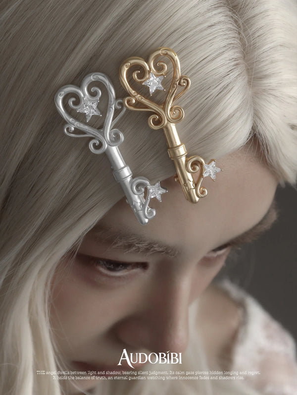 Winged Grace Key Hair Clip, shown worn by a model.