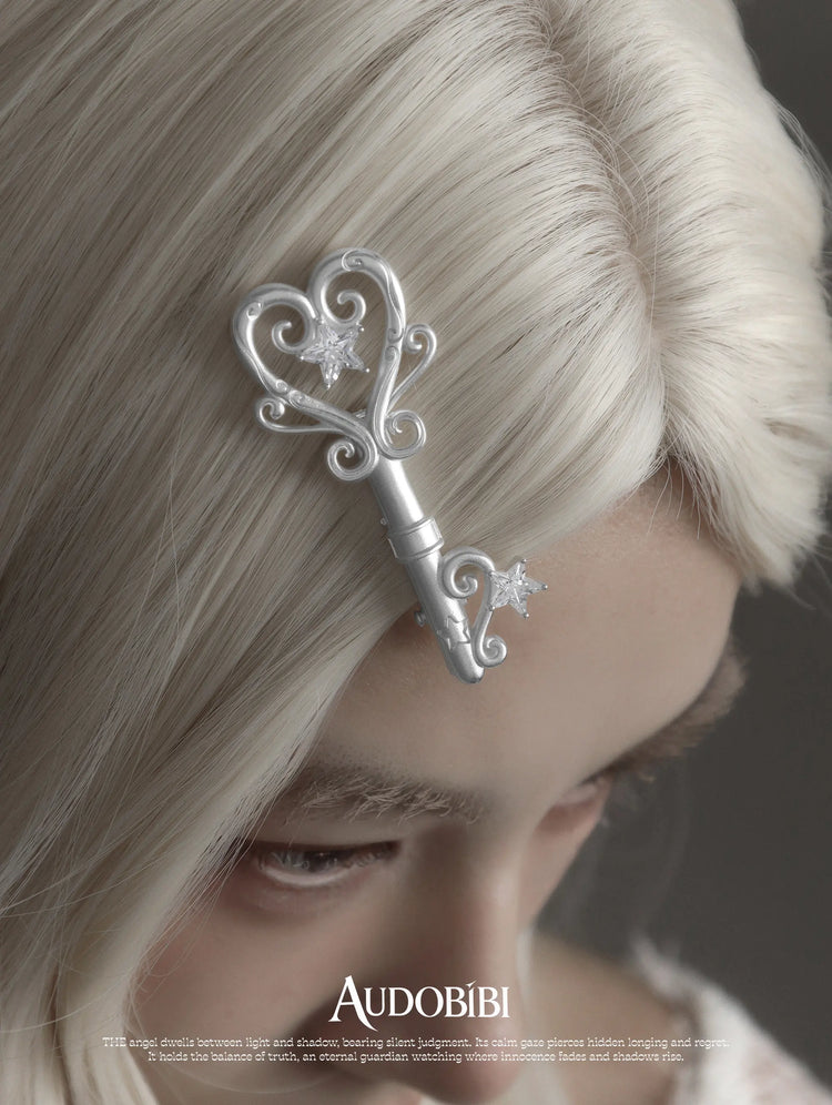 Winged Grace Key Hair Clip, shown worn by a model.