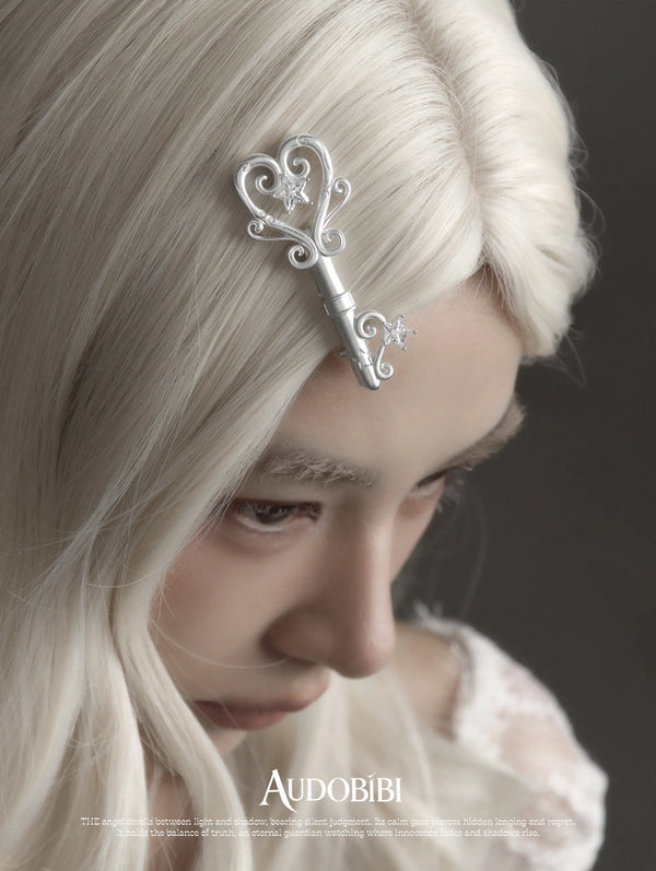 Winged Grace Key Hair Clip, shown worn by a model.
