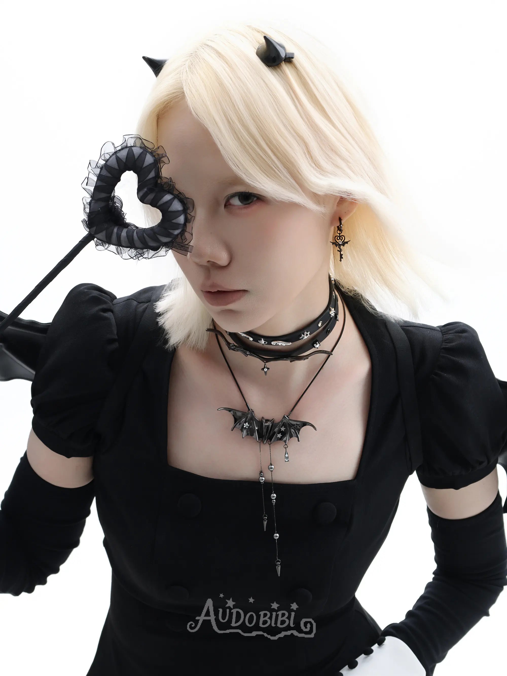 Angel and Devil leather straps with winged hardware, shown worn as bracelets.