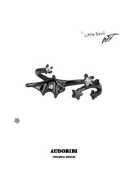 Black bat-wing open ring with small star details.