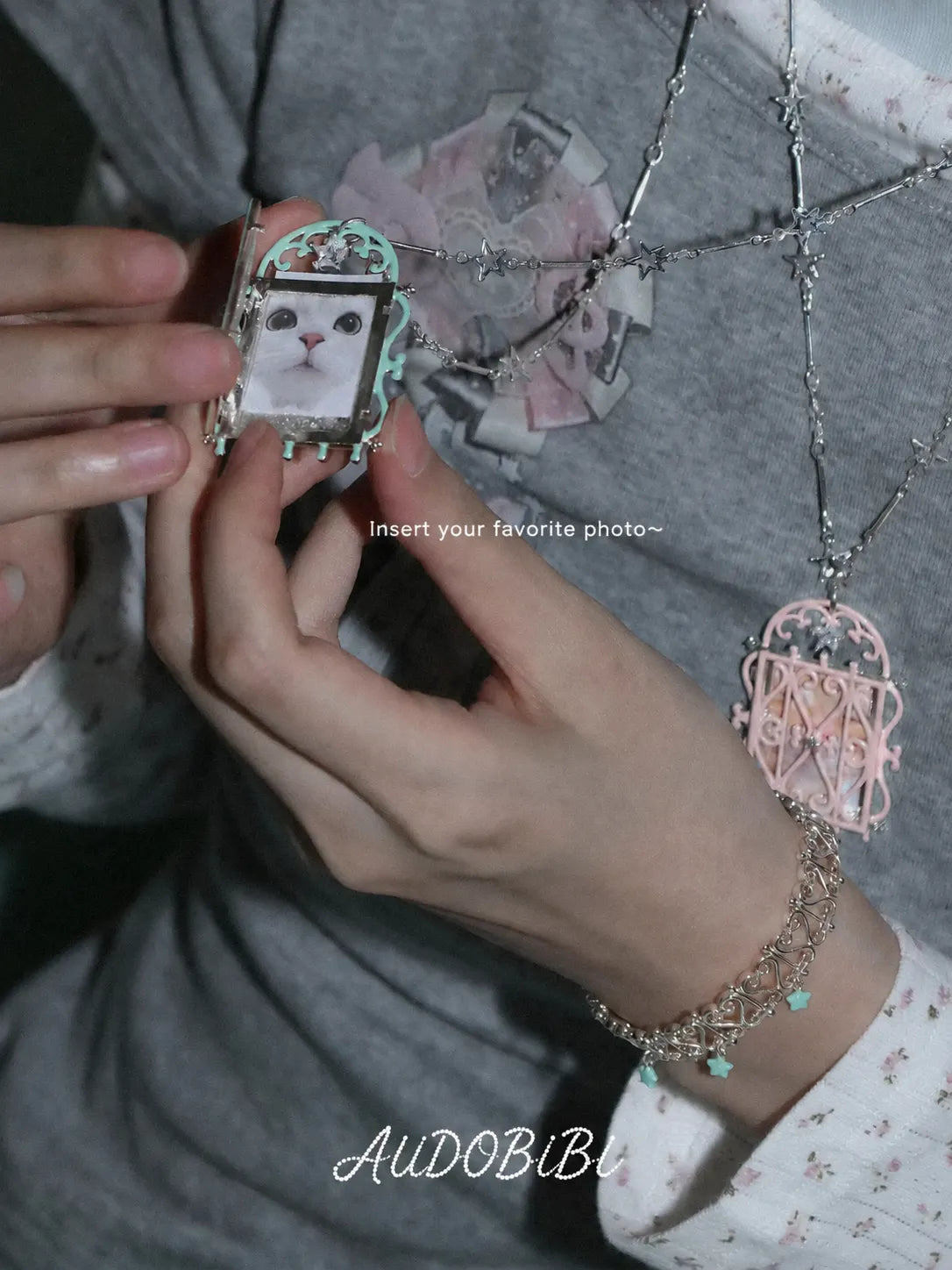 Window-shaped photo locket necklace, shown on the hand or wrist with other jewelry.