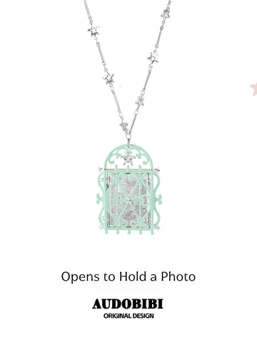 Window-shaped photo locket necklace, shown on the hand or wrist with other jewelry.