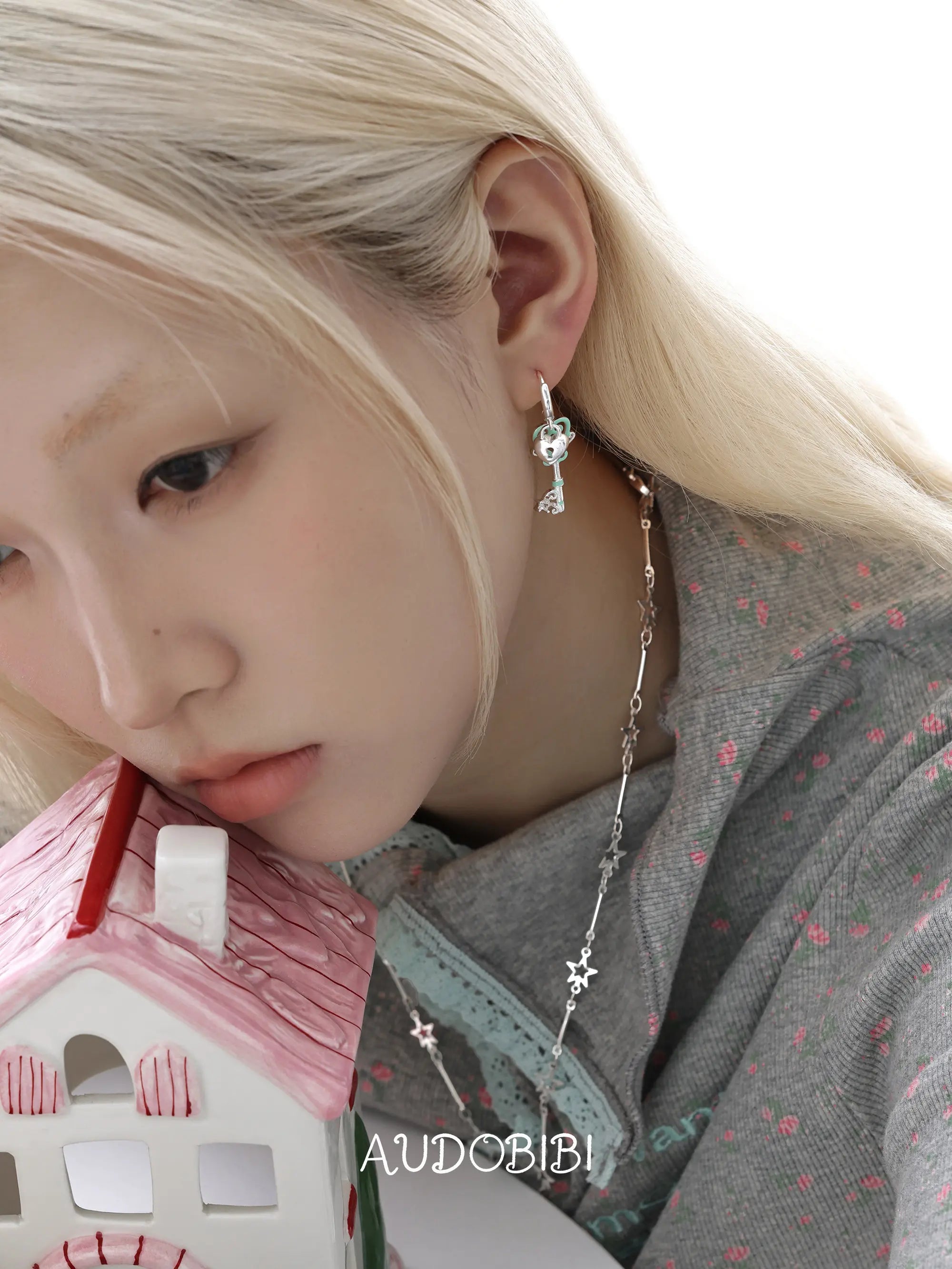 Lily Dreamlock Asymmetric Heart-Key Drop Earrings, shown worn by a model.