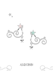 Mint and pink star studs with scrolling drops on a white background.