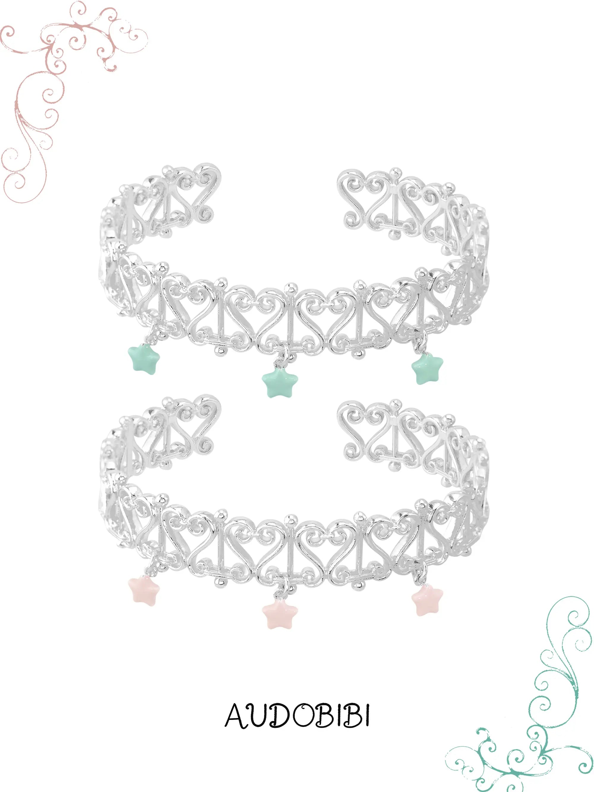 Two openwork bangles with mint and pink star drops.