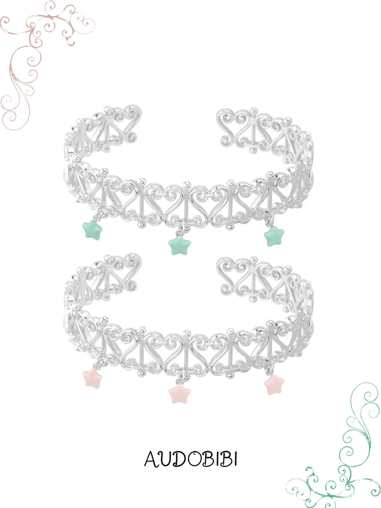 Two openwork bangles with mint and pink star drops.