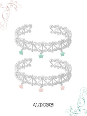 Two openwork bangles with mint and pink star drops.
