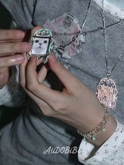 Openwork bangle with colored star drops, shown on the hand or wrist with other jewelry.