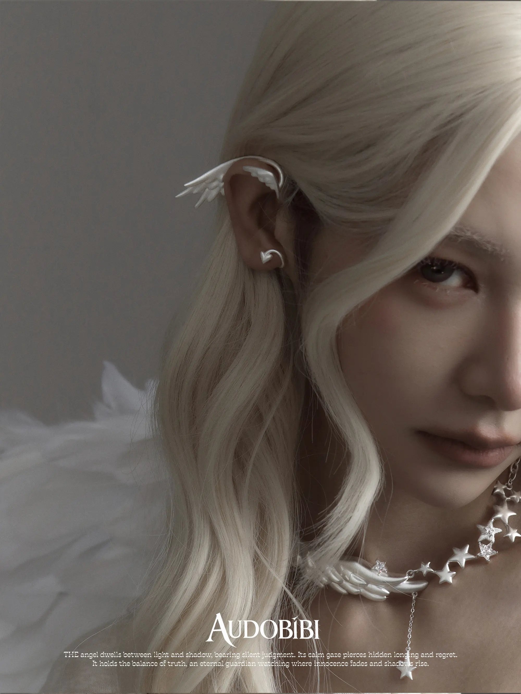 Wing ear cuff, worn with other jewelry in a model portrait.