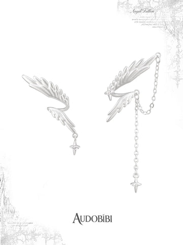 Asymmetric wing earrings with feather and chain drops on a white background.