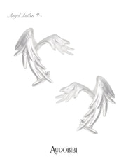Two long wing ear cuffs on a white background.