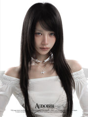 Wing choker with a draped chain, worn with other jewelry in a model portrait.