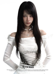 Wing choker with a draped chain, worn with other jewelry in a model portrait.