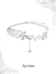 Wing-and-star pendant necklace with a small hanging star.